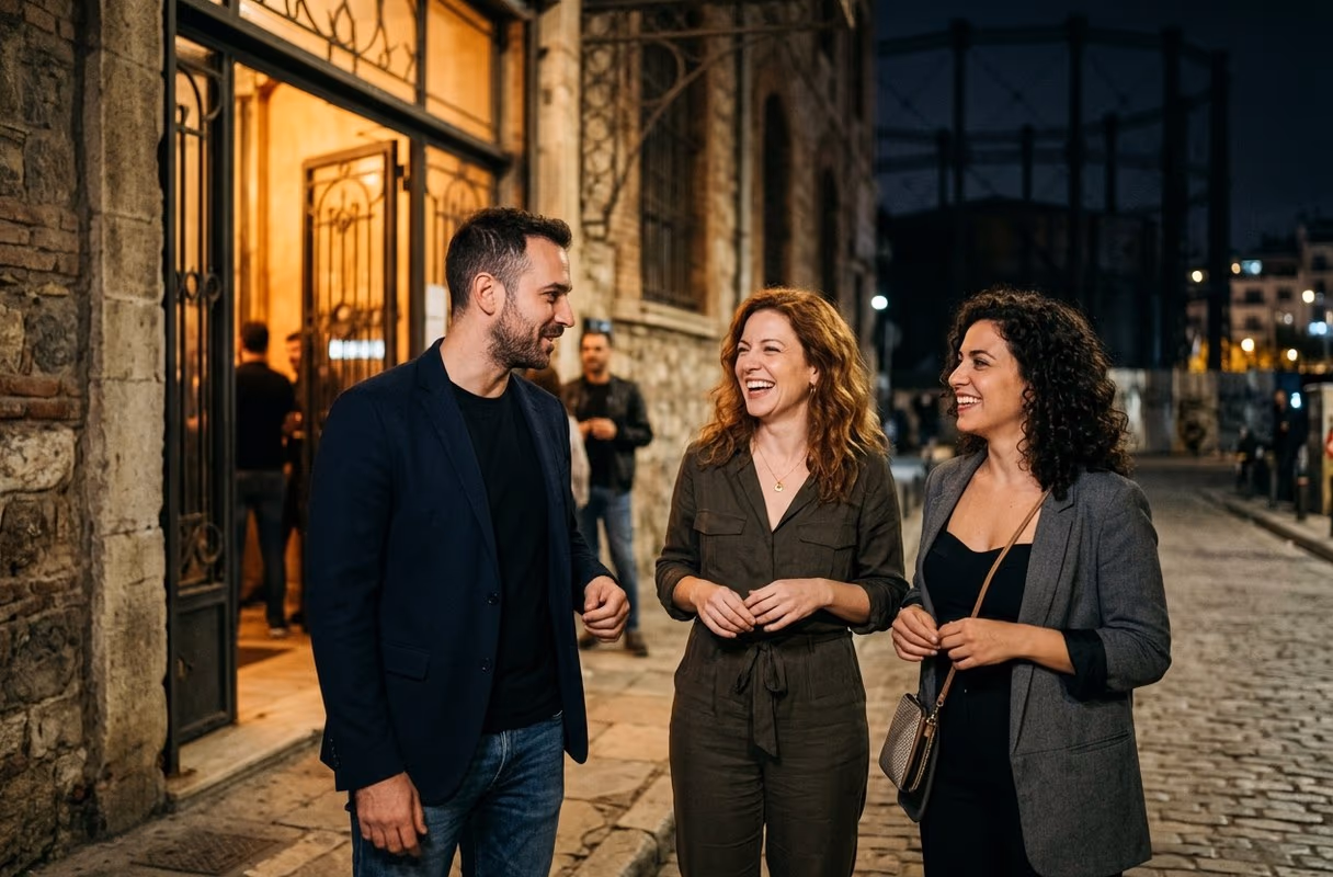 Gazi — the district where Athens is most itself after dark Three people talking outside a club entrance in the Gazi district of Athens at night