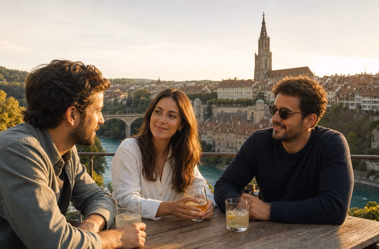 Above the Aare — Bern's understated setting for a first meeting Three people talking on a terrace above the Aare bend with Bern's old town behind