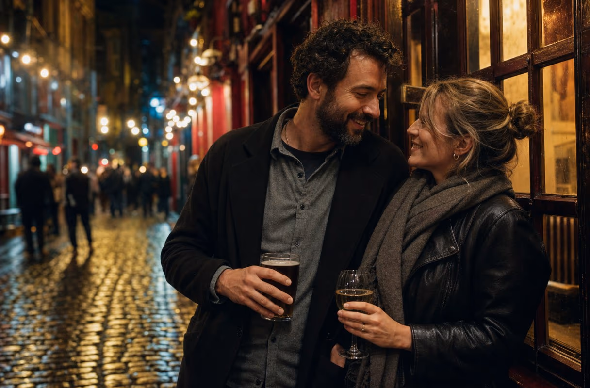 A couple leaning close together on a cobbled Temple Bar lane at night