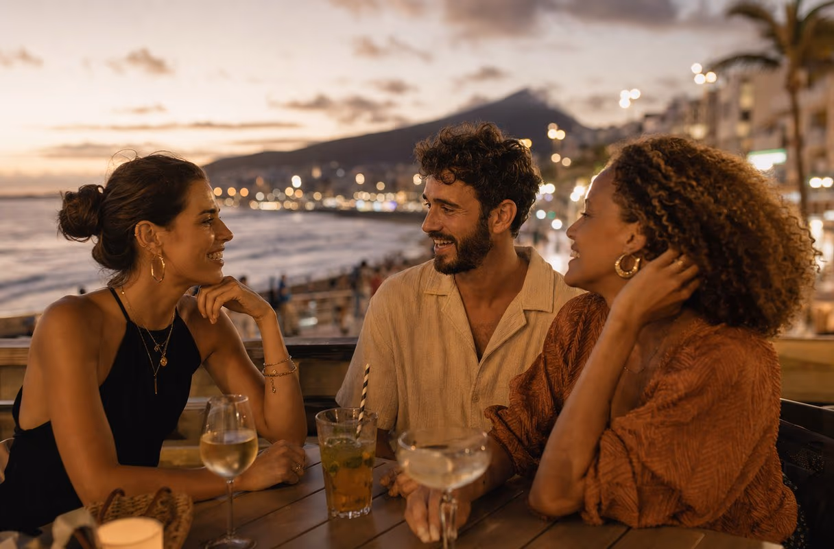 A small group talking on the Las Canteras promenade in Las Palmas in the evening