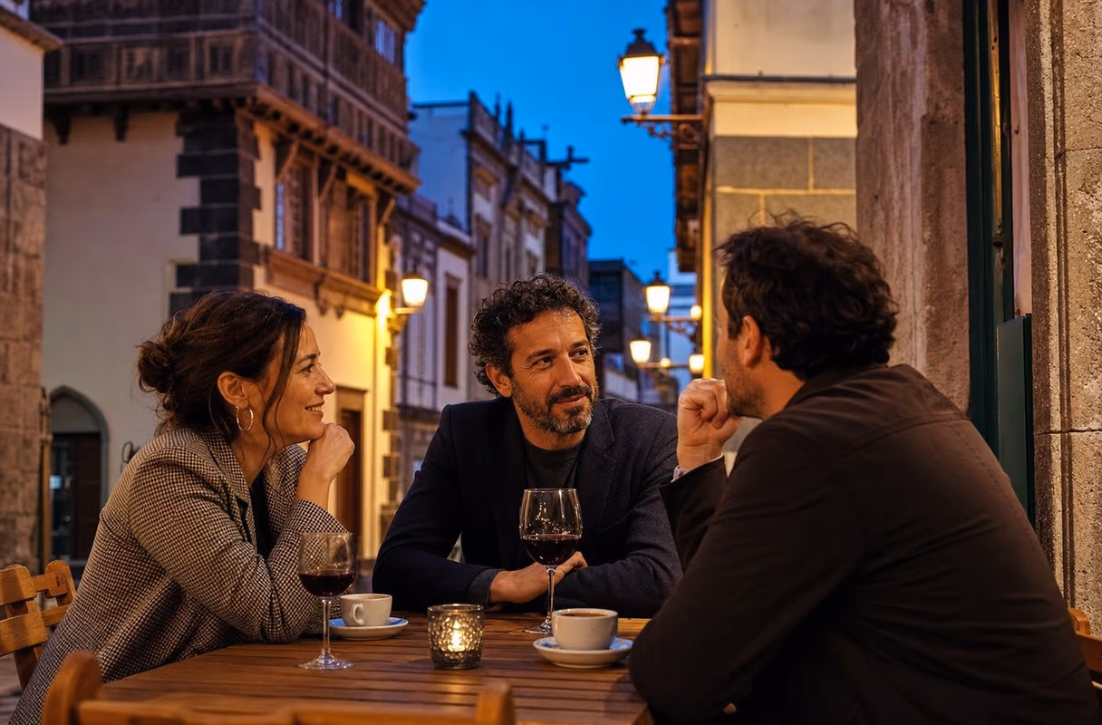 A couple and a friend at a small terrace between historic facades in Vegueta, Las Palmas
