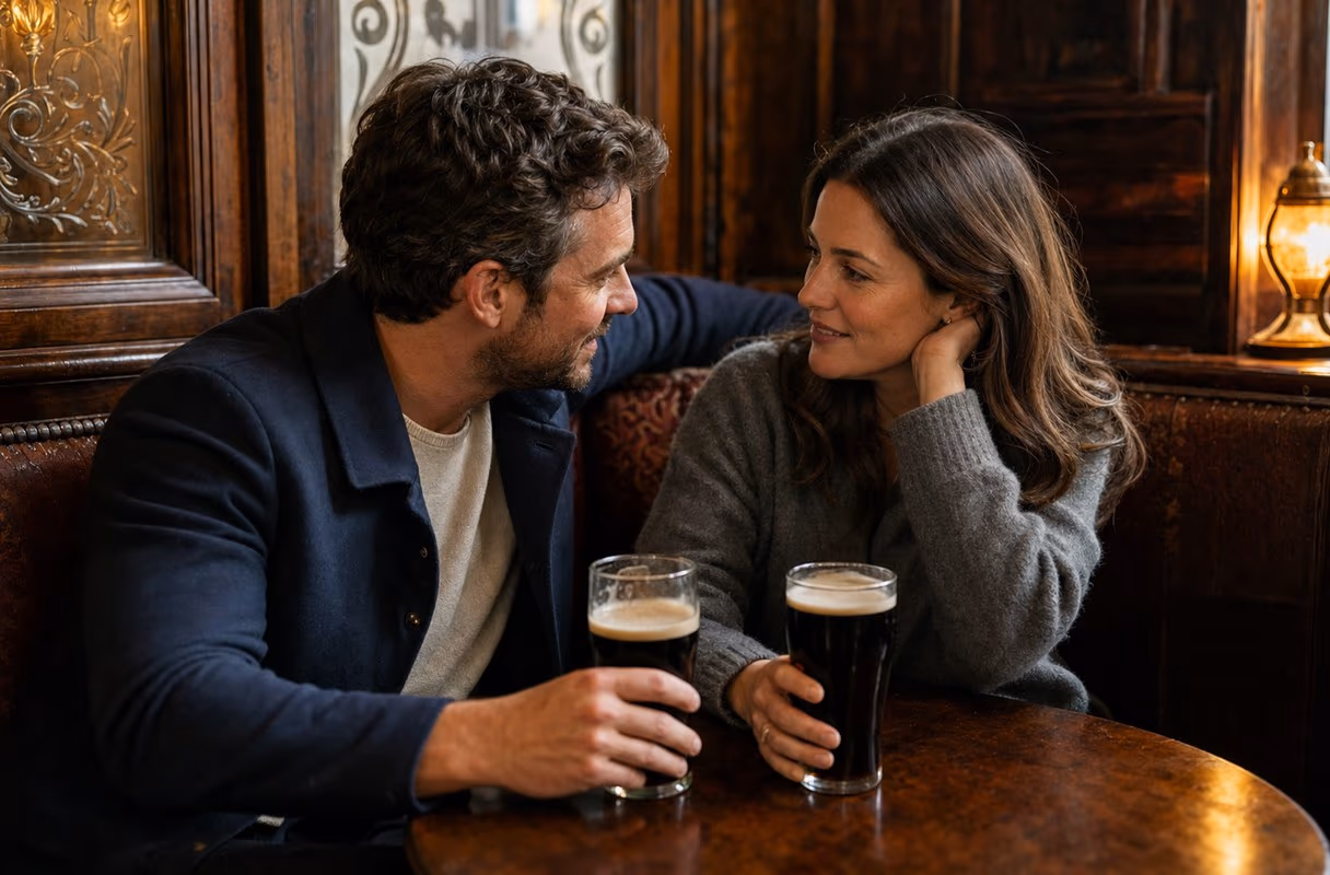A couple talking quietly in the wooden snug of a traditional Dublin pub